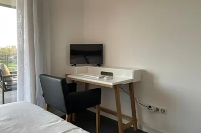 a room with a desk with a computer and a chair at Two-bedroom flat with terrace near the harbour and town centre in Porto-Vecchio