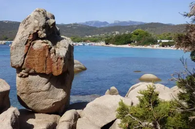 a large rock sitting next to a body of water at Rez de jardin dans une résidence de charme ... in Porto-Vecchio