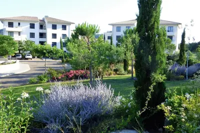 a garden in front of a apartment building at Rez de jardin dans une résidence de charme ... in Porto-Vecchio