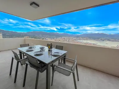 a dining room with a table and chairs with a view at Les terrasses de Toretta in Ajaccio