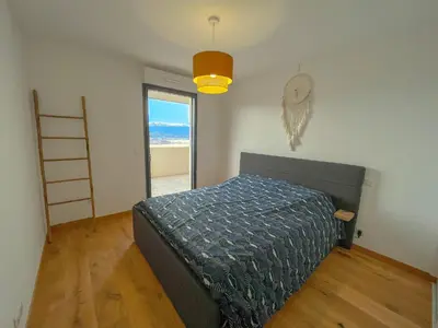 a bedroom with a bed in a room with a ladder at Les terrasses de Toretta in Ajaccio