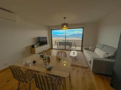 a living room with a couch and a table at Les terrasses de Toretta in Ajaccio