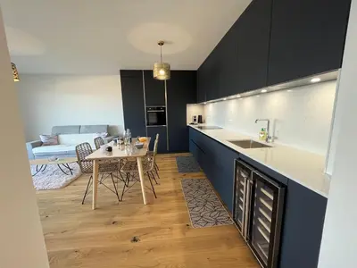a kitchen and living room with a table and a counter at Les terrasses de Toretta in Ajaccio