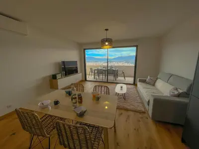 a living room with a couch and a table at Les terrasses de Toretta in Ajaccio