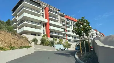 a large apartment building with a parking lot at Les terrasses de Toretta in Ajaccio