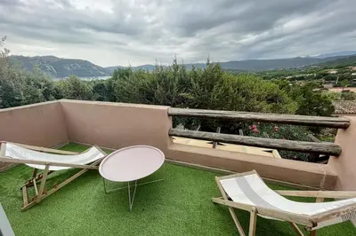 a patio with two chairs and a table and chairs at Charming Duplex In Porto Vecchio in Porto-Vecchio
