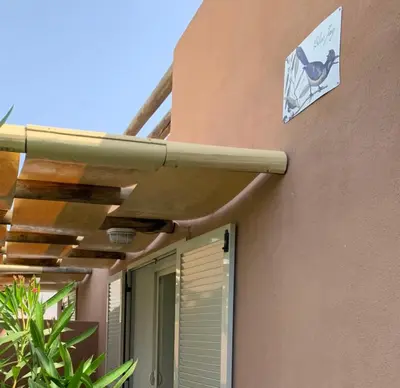a pipe on the side of a building with a sign on it at Charming Duplex In Porto Vecchio in Porto-Vecchio