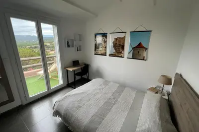 a bedroom with a bed and a window and a desk at Charming Duplex In Porto Vecchio in Porto-Vecchio