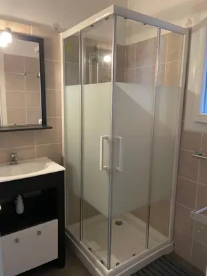 a glass shower in a bathroom with a sink at Charming Duplex In Porto Vecchio in Porto-Vecchio