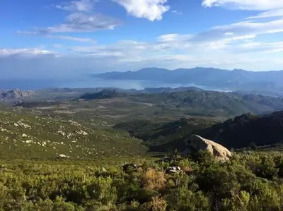 a view of a valley with mountains in the distance at SEJOUR DETENTE BALAGNE ENTRE MER ET MONTAGNE in Urtaca