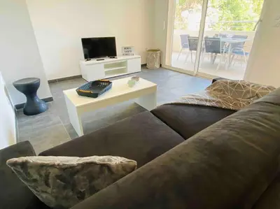 a living room with a couch and a table at Monte Santu T2 in Prunelli-di-Fiumorbo