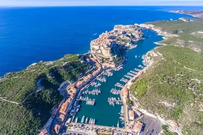 an aerial view of a castle on a hill next to the ocean at Monte Santu T2 in Prunelli-di-Fiumorbo