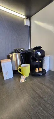 a table with a yellow coffee cup and a bag at Villa 78 Alba Rossa Piscine chauffée et Plage de Cupabia in Serra-di-Ferro