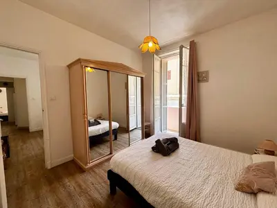 a bedroom with a mirror and a bed in it at Casamea - Escapade en bord de mer, Accès plage in Ajaccio