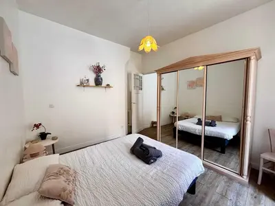 a bedroom with two beds and a mirror at Casamea - Escapade en bord de mer, Accès plage in Ajaccio