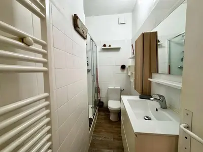 a white bathroom with a sink and a toilet at Casamea - Escapade en bord de mer, Accès plage in Ajaccio