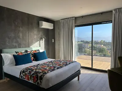 a hotel room with two beds and a balcony at Hôtel Casa Matteu in Afa