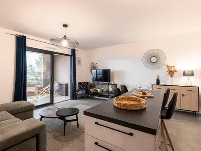 a kitchen and living room with a couch and a table at Apartment St Joseph-2 by Interhome in Porto-Vecchio