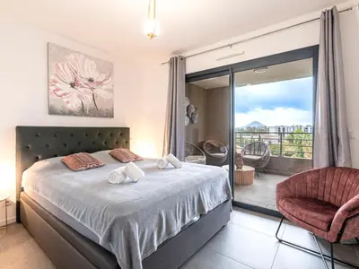a bedroom with a bed and a balcony at Apartment St Joseph-2 by Interhome in Porto-Vecchio