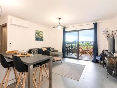 a kitchen and living room with a table and chairs at Apartment St Joseph-2 by Interhome in Porto-Vecchio