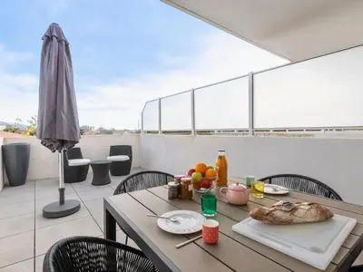a table with a plate of food on a balcony at Apartment La Boétie A by Interhome in Porto-Vecchio