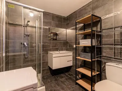 a bathroom with a shower and a toilet and a sink at Apartment La Boétie A by Interhome in Porto-Vecchio