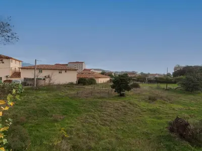 a view of a field with houses in the background at Apartment La Boétie A by Interhome in Porto-Vecchio