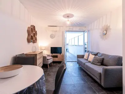 a living room with a couch and a table at Apartment La Boétie A by Interhome in Porto-Vecchio