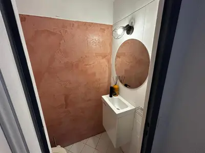 a small bathroom with a sink and a mirror at Villa l'Albizia accès privé rivière in Porto-Vecchio