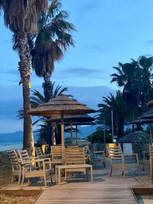 a group of chairs and umbrellas on a beach at CASA MARE in Ghisonaccia