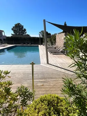 a swimming pool with a net on a wooden deck at Villa U Sanda in Lecci
