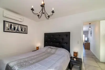 a bedroom with a large bed with a black headboard at Les terrasses de l'Isolella in Porticcio