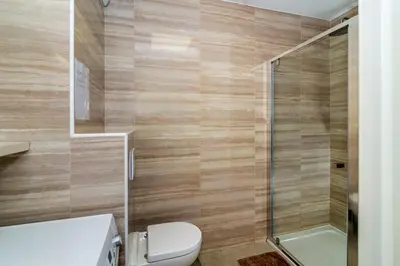a bathroom with a toilet and a shower at Les terrasses de l'Isolella in Porticcio