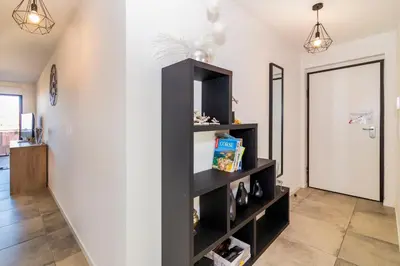 a black book shelf in a room with a door at Les terrasses de l'Isolella in Porticcio