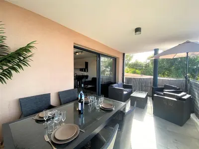 a dining room with a table with wine glasses and sidx sidx sidx sidx at Les terrasses de l'Isolella in Porticcio