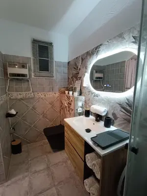 a bathroom with a sink and a mirror at chambre d'hôte cosy L'AGHJA in Carbuccia