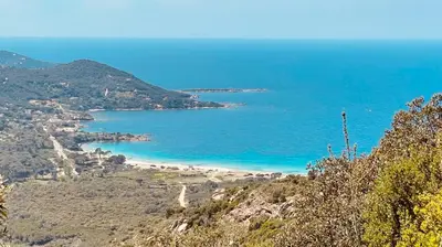 a view of a beach on a hill with the ocean at chambre d'hôte cosy L'AGHJA in Carbuccia