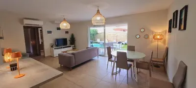 a living room with a table and a couch at villa Pinarello in Pinarellu