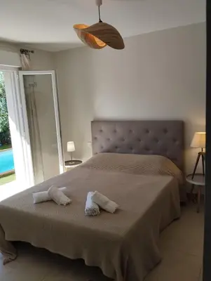 a bedroom with a bed with two towels on it at villa Pinarello in Pinarellu