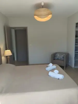 a bedroom with a bed with towels on it at villa Pinarello in Pinarellu