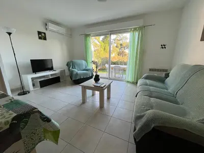 a living room with a couch and a table at Villa Melody duplex climatisée piscine in Santa-Maria-Poggio