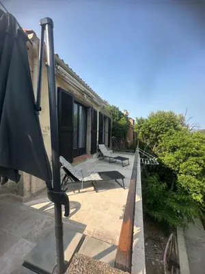 a patio with two benches and a house at casa in Palasca