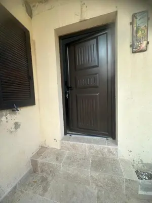 a black door on the side of a building at casa in Palasca