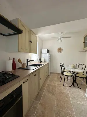 a kitchen with a table and chairs and a counter top at casa in Palasca