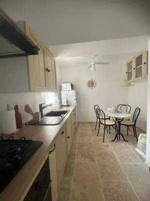 a kitchen with a table and chairs and a counter top at casa in Palasca