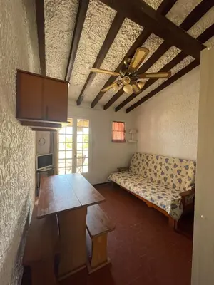 a living room with a couch and a ceiling fan at RESIDENCE LA PLAGE Pieds dans l'eau Belle Vue mer in Linguizzetta
