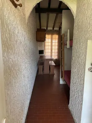 an empty hallway of a room with a kitchen and a table at RESIDENCE LA PLAGE Pieds dans l'eau Belle Vue mer in Linguizzetta