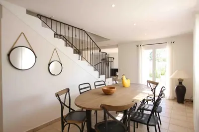 a dining room with a wooden table and chairs at Residence Catherine in Calvi