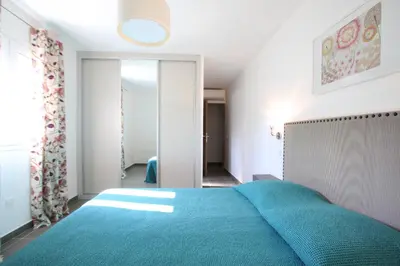 a bedroom with a blue bed in a room at Residence Catherine in Calvi