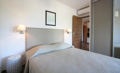 a bedroom with a large bed in a room at Residence Catherine in Calvi